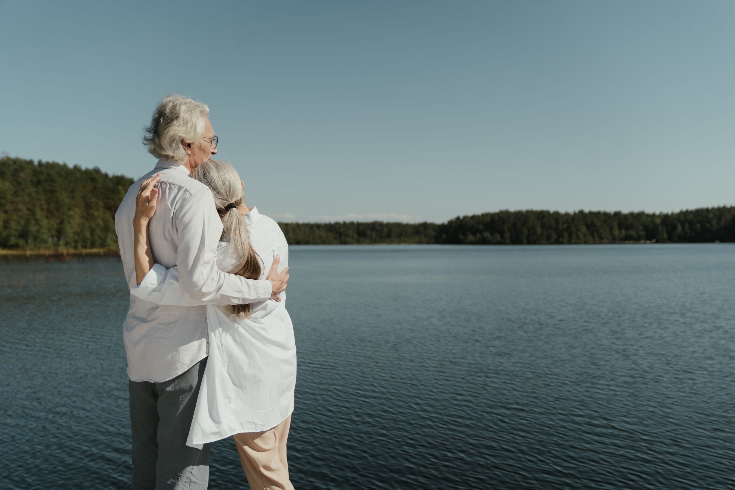 A happy senior couple embracing outdoors